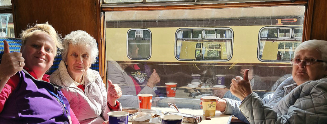 Clients enjoying a steam train trip with our team
