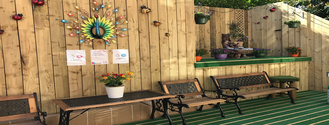 The sensory garden at Happy Days with benches and colourful decorations